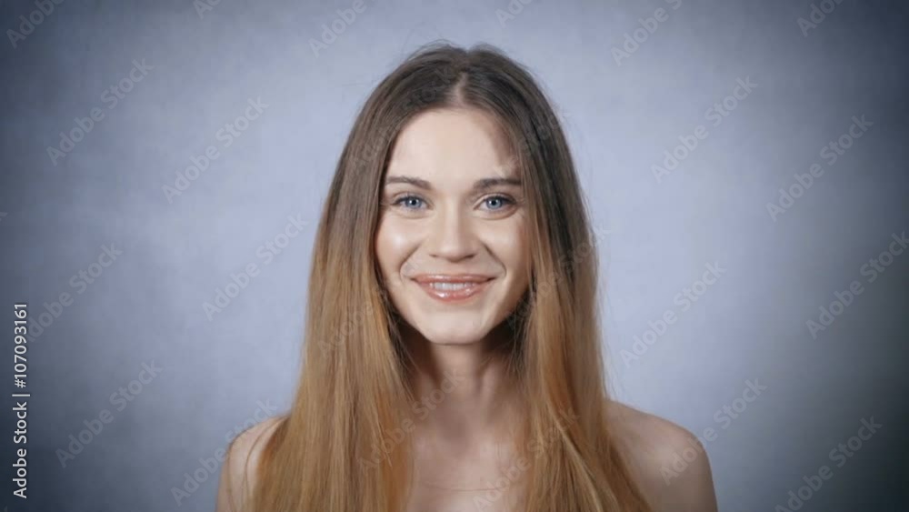 Portrait of beautiful blonde cheerful woman on grey background. Portrait of beautiful blonde cheerful woman on grey background.