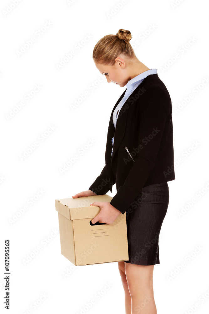 Sad business woman carrying box after loosing job Sad business woman carrying box after loosing job