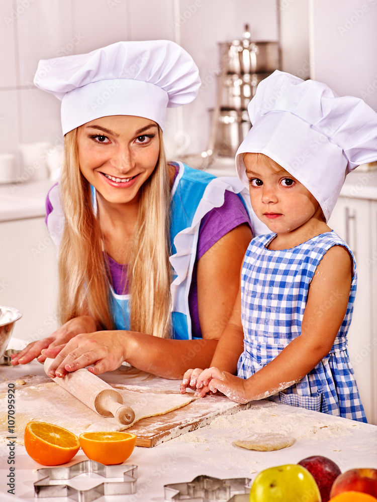 Mother and daughter baking cookies. Help mother in early childhood. Mother and daughter baking cookies. Help mother in early childhood.