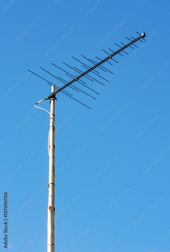 Television antenna against the blue sky background Television antenna against the blue sky background
