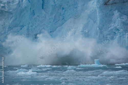 glacial ice falling onto water in a glacial lagoon