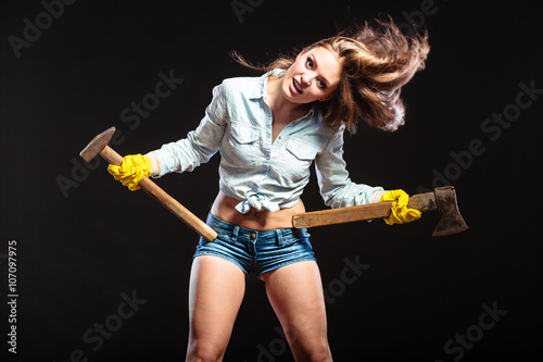 Sexy strong woman feminist with axes working.