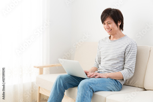 young asian man using laptop computer © taka