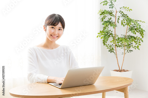 young asian woman using laptop computer © taka