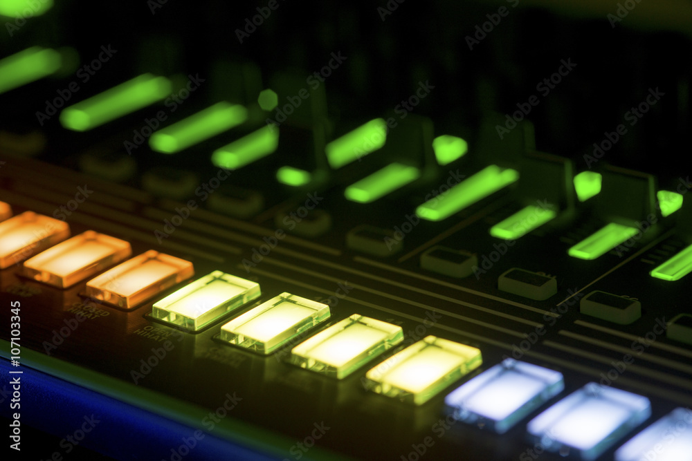 Lit buttons on a mixing panel