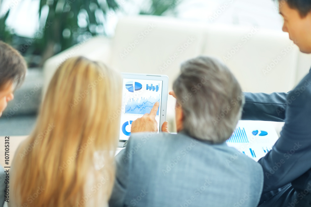 Image of business partners discussing financial schedule Image of business partners discussing financial schedule