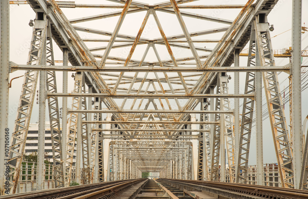 Railroad bridge of steel, inside view passes over the river