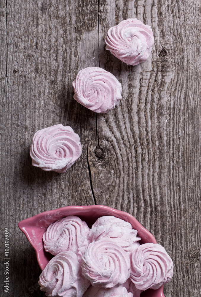 Fresh pink homemade zephyr - marshmallow on old wooden table Fresh pink homemade zephyr - marshmallow on old wooden table