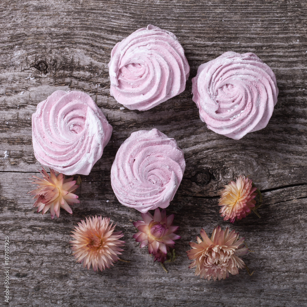 Fresh pink homemade zephyr - marshmallow on old wooden table Fresh pink homemade zephyr - marshmallow on old wooden table
