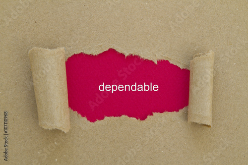 Dependable word written under torn paper.
