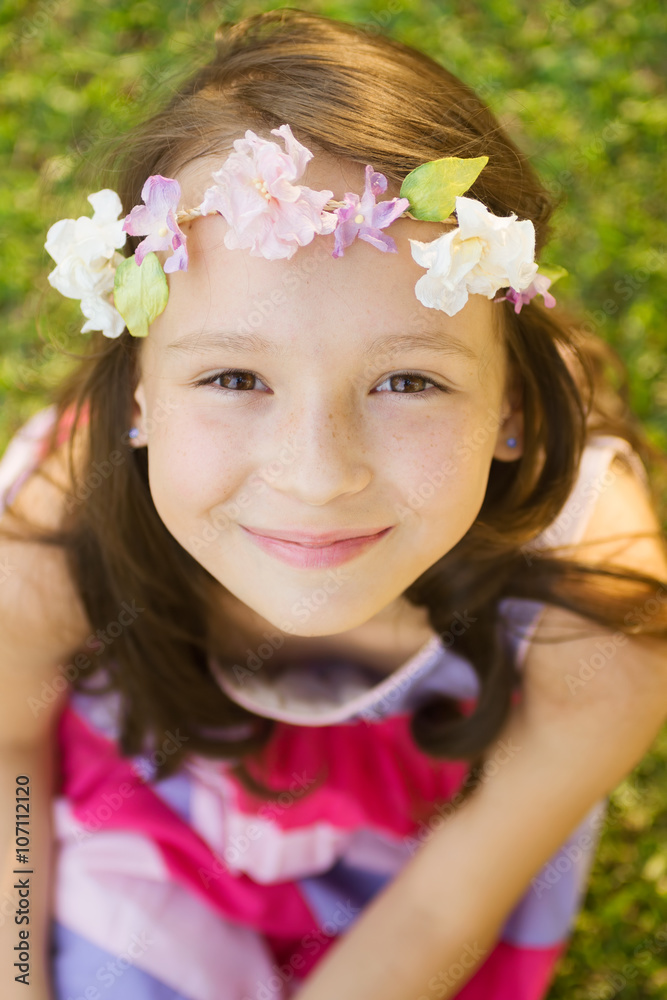 smiling caucasian girl with curly hair on grass smiling caucasian girl with curly hair on grass