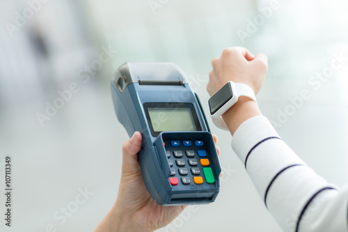 Woman using smart watch to pay by NFC technology