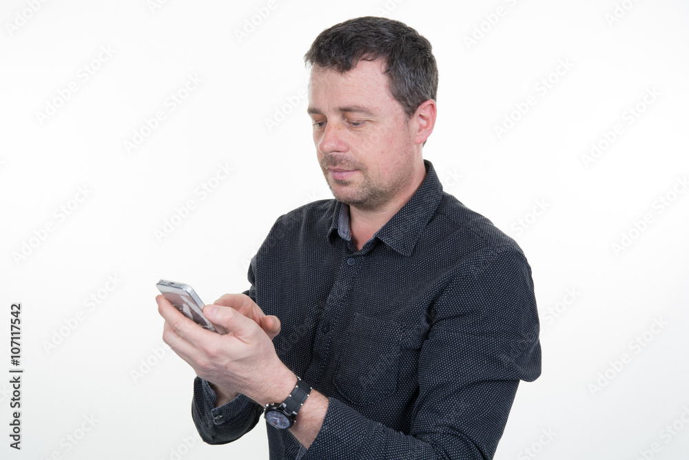 Male hand holding a cell phone and writing sms message Male hand holding a cell phone and writing sms message