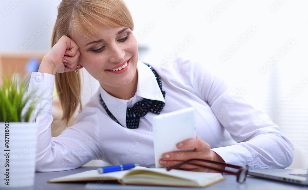Portrait of businesswoman sitting at desk with a laptop Portrait of businesswoman sitting at desk with a laptop