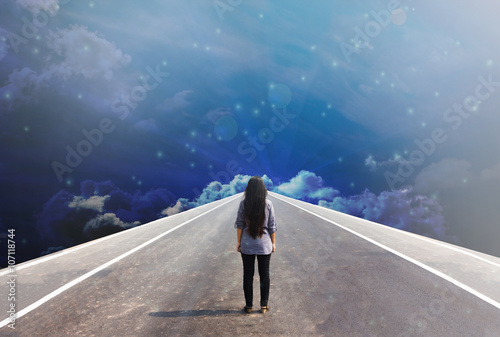 Back or rare of women standing on the road in dreamy fantasy sky