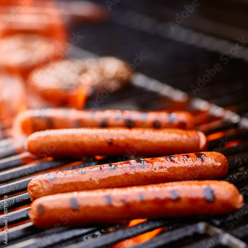 grilling hot dogs over open flame