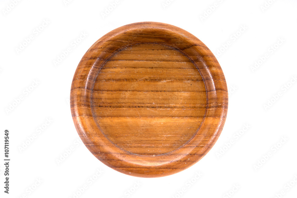 A round hand craft wooden saucer, wooden bottom plate isolated o A round hand craft wooden saucer, wooden bottom plate isolated o