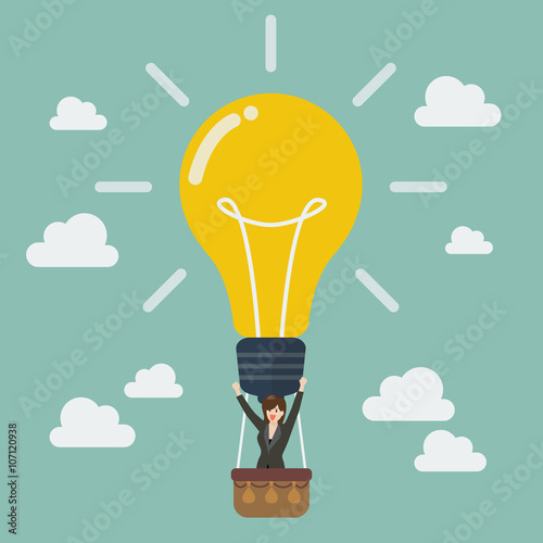 Business woman celebrating in lightbulb balloon