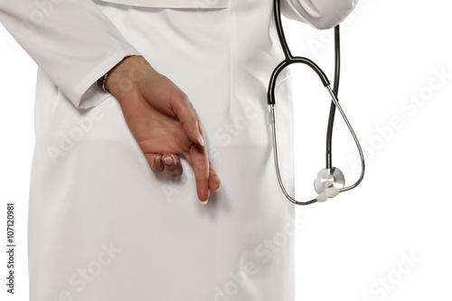 A young woman doctor of the crossing her fingers. The gesture to lie