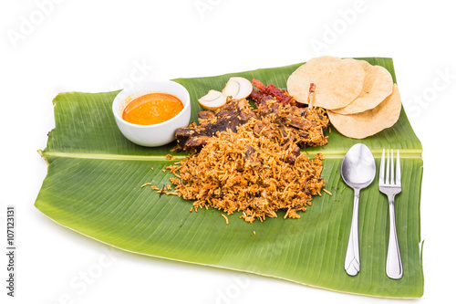 Delicious nasi briyani meal with mutton,  dhal on banana leaf