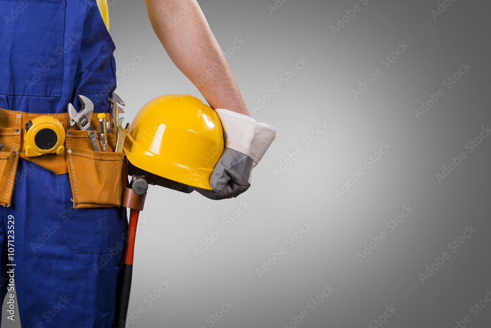 construction worker holding helmet on gray background with copy construction worker holding helmet on gray background with copy