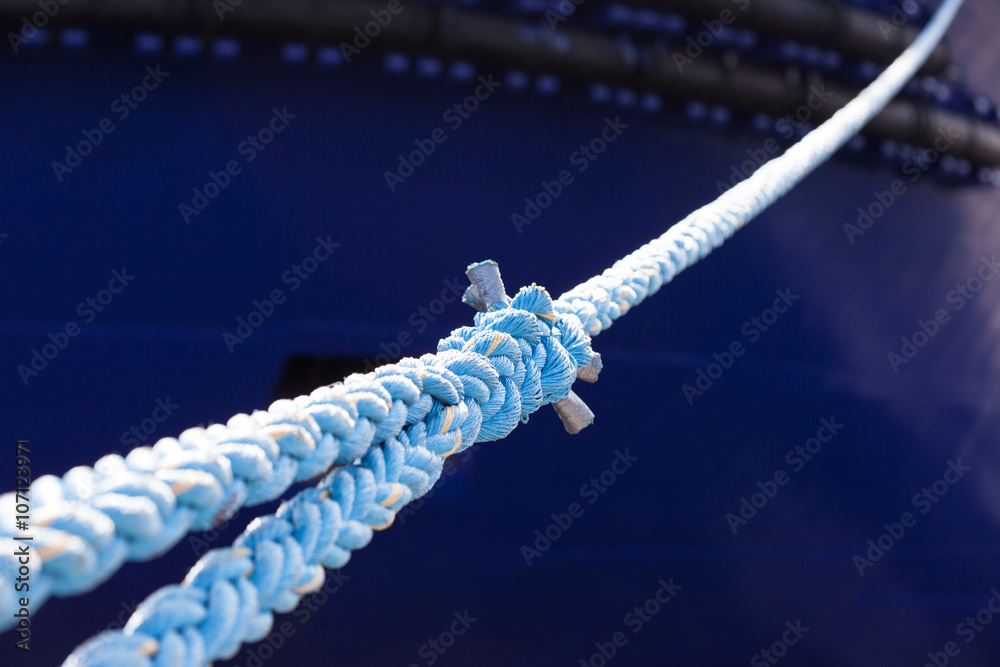 rope anchoring the ship backgriund. mooring end rope anchoring the ship backgriund. mooring end