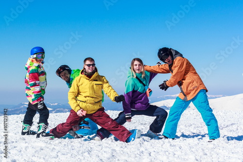 young cheerful people on a snowy mountain