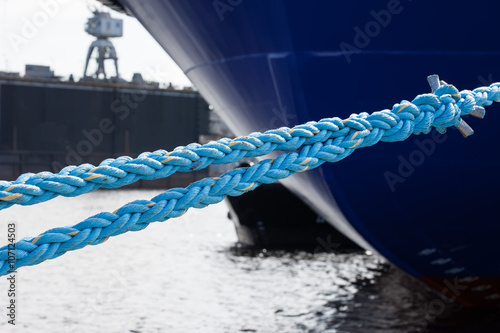 rope anchoring the ship backgriund. mooring end