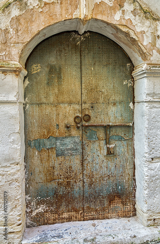 Old weathered door in the m...