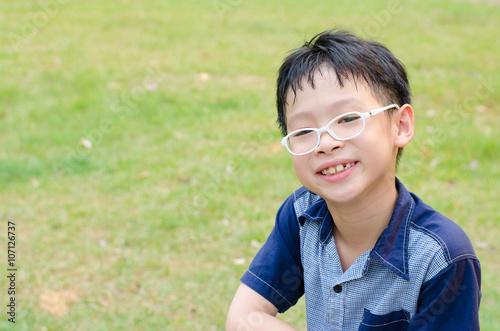 Young Asian boy smiling in park
