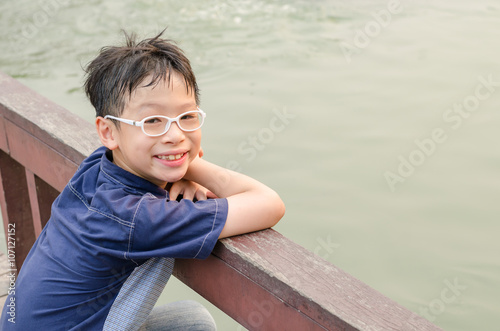 Young Asian boy smiling outdoor © gamelover