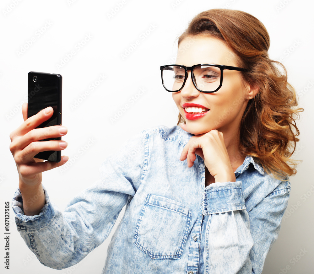  Smiling cheerful blond-haired woman doing selfie