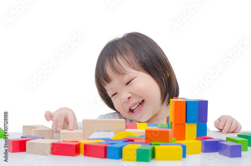 ittle Asian girl playing colorful wood blocks