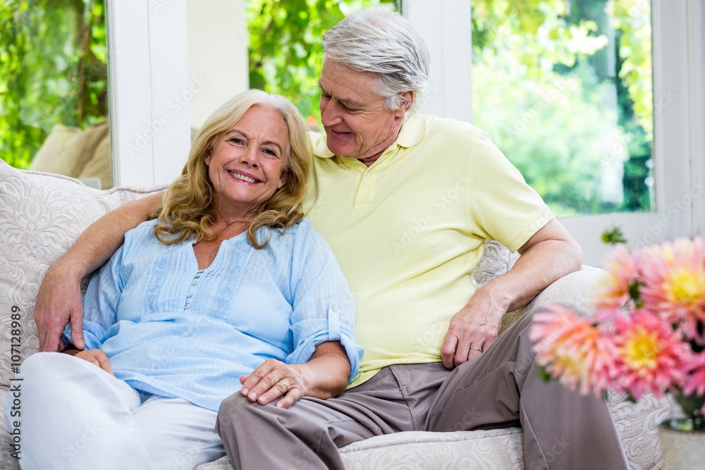 Romantic senior couple sitting on sofa at home Romantic senior couple sitting on sofa at home