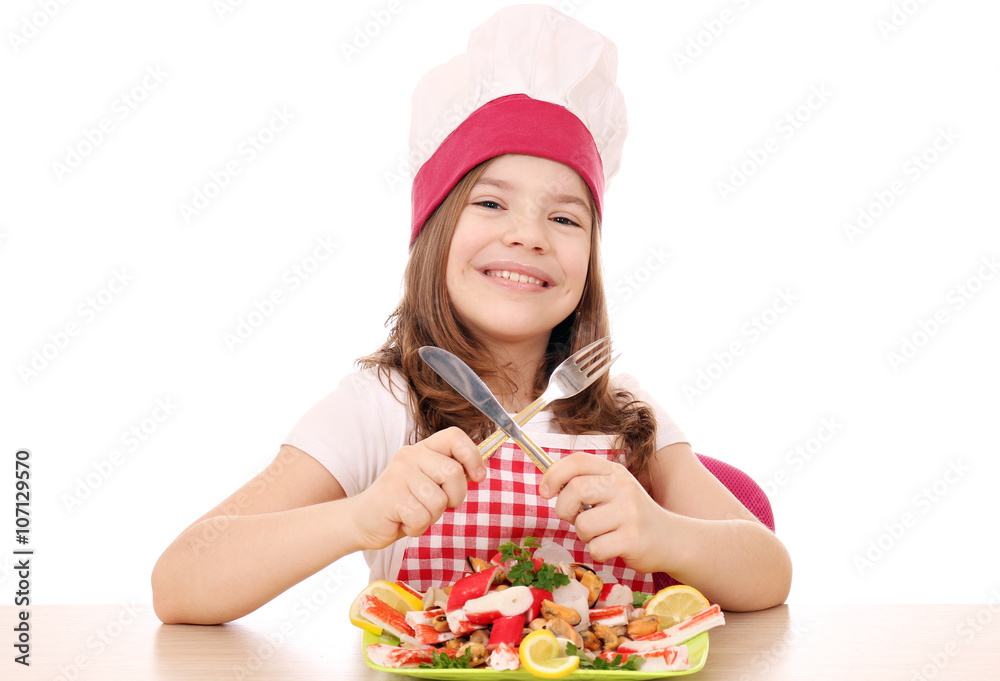 happy little girl cook with seafood on table happy little girl cook with seafood on table
