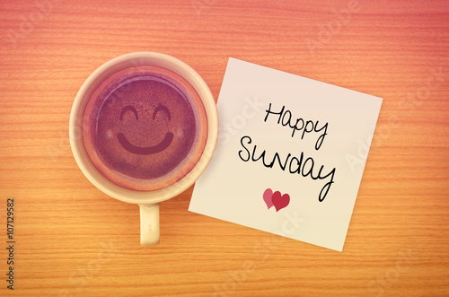 Happy Sunday on paper note with coffee cup,top view.