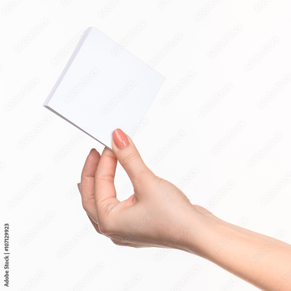 Female hand holding blank paper for records on white. Female hand holding blank paper for records on white.