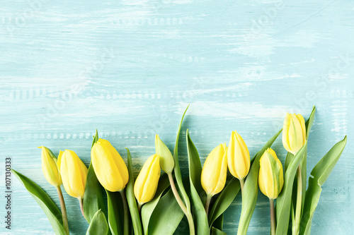Fototapeta Naklejka Na Ścianę i Meble -  Yellow tulips over wooden table