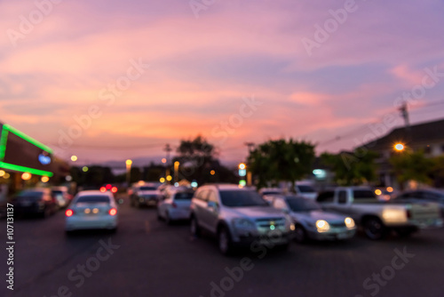 blur of colorful sky in twilight time above car park © bouybin