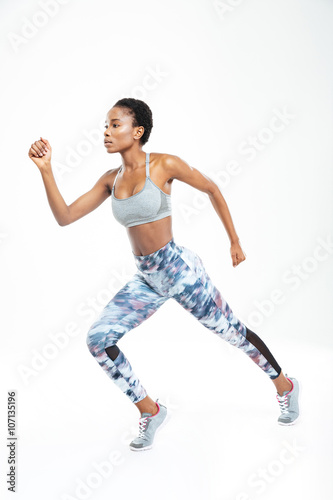Concentrated beautiful young african american sportswoman running
