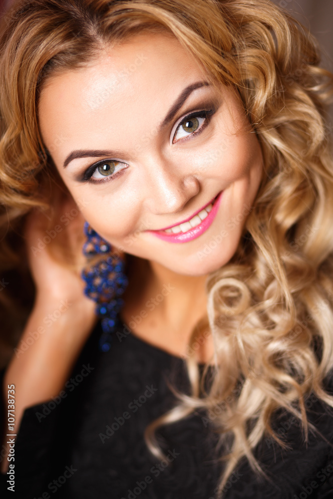 Fototapeta premium Close-up portrait of beautiful curly young woman with perfect makeup and hairstyle. Beauty fashion portrait