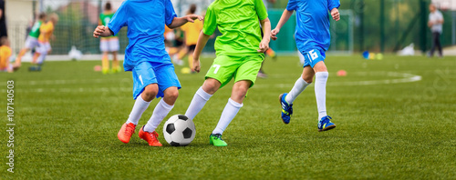Young boys playing youth soccer football game. Youth sport tournament