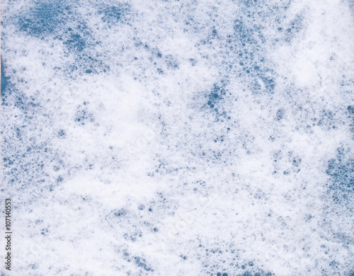 Soap foam on blue background background. Sea foam.