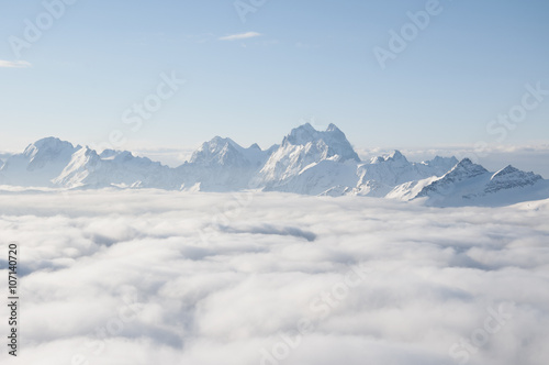 Mountain ridge sticking out of the clouds