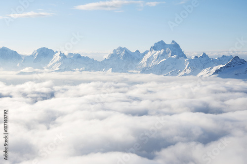 Sharp mountain peaks sticking out of clouds