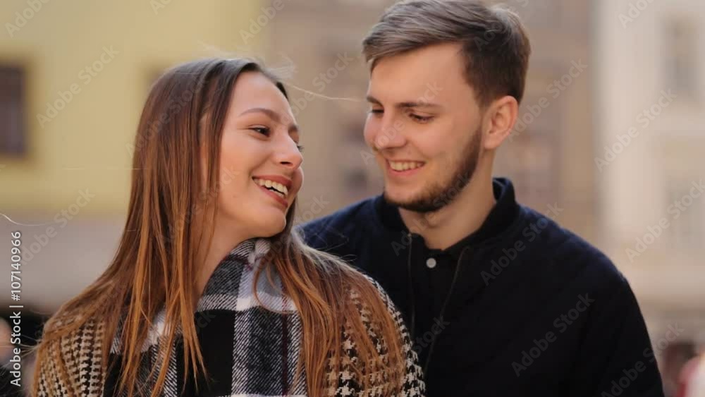 Close up of two lovers holding hands, hugging and talking to each others on the street. Close up of two lovers holding hands, hugging and talking to each others on the street.