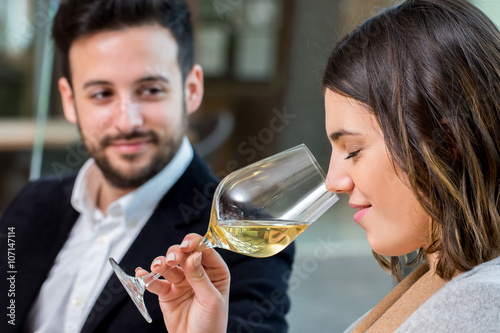 Obraz na płótnie Woman smelling white wine at tasting.