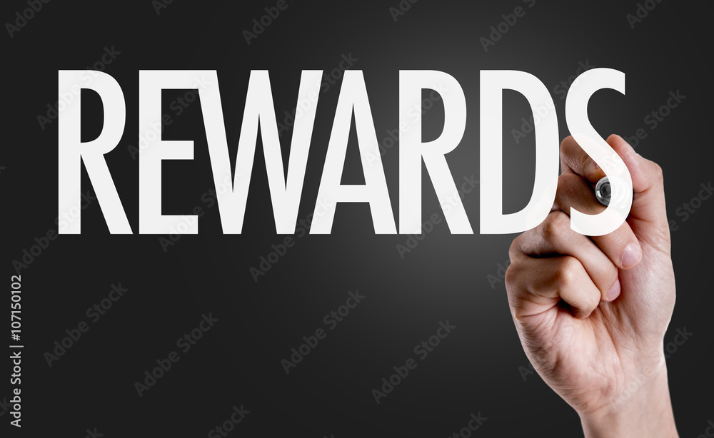 Hand writing the text: Rewards Hand writing the text: Rewards