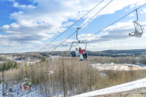 skiers ride the ski chair lift up