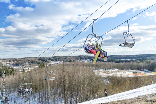 skiers ride the ski chair lift up